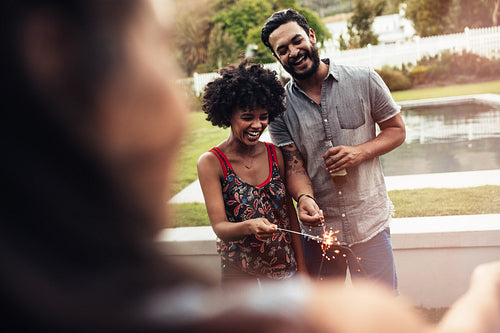 Group of friends hanging out and having fun with fireworks