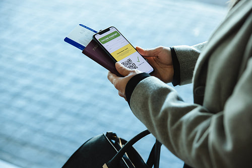 Woman at airport with immunity passport during pandemic
