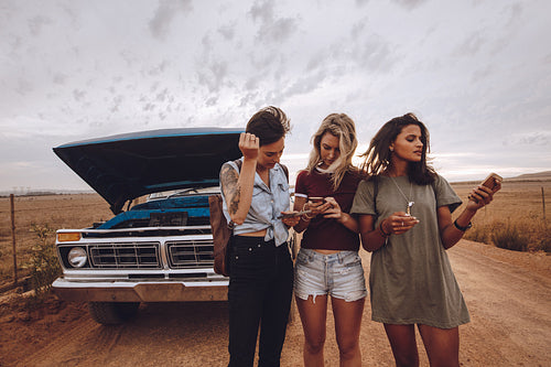 Woman using phones for road assistance