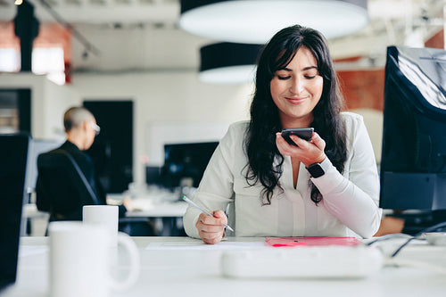 Creative businesswoman making a phone call in the office
