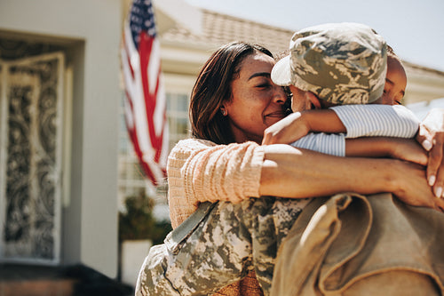 American soldier saying farewell to his family at home