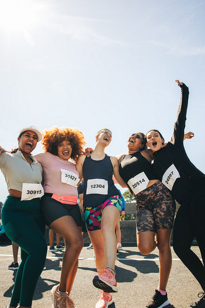 Group of happy friends participating in a fun run event