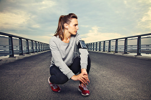Fitness Runner on the Bridge Resting