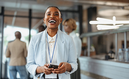 Successful business woman laughing happily at a modern conference event