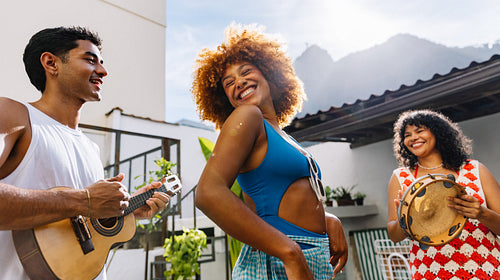 Group of three friends enjoying samba and guitar music outdoors in Rio de Janeiro