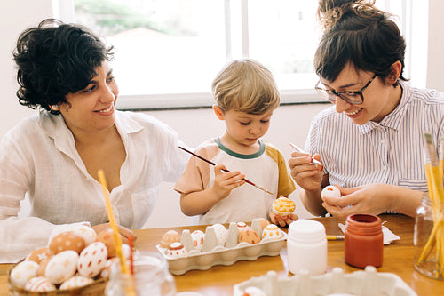 Lesbian family painting easter eggs