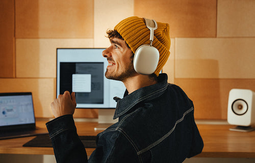 Young man enjoys digital creativity at a modern office space