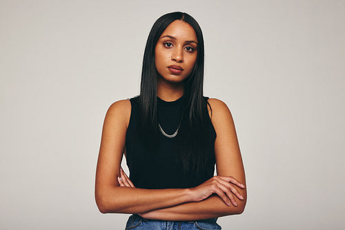Stylish young woman looking at the camera in a studio