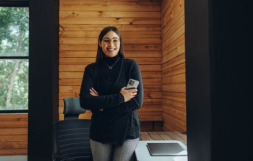 Successful businesswoman smiling happily in a coworking office