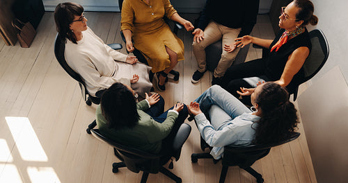 Multiracial office team practicing mindfulness together for mental wellness