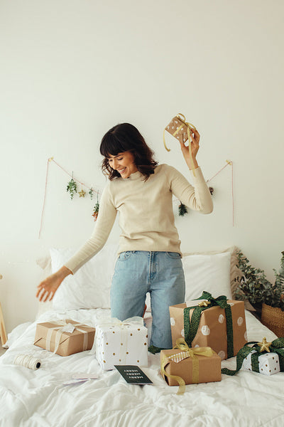Woman playing with her christmas presents