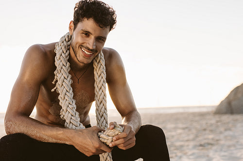 Man relaxing at the beach after workout