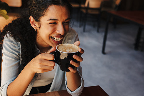 Woman enjoying having coffee at a cafe