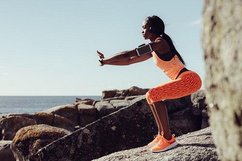 Woman runner doing stretching exercises.