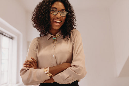Businesswoman standing at home with arms crossed