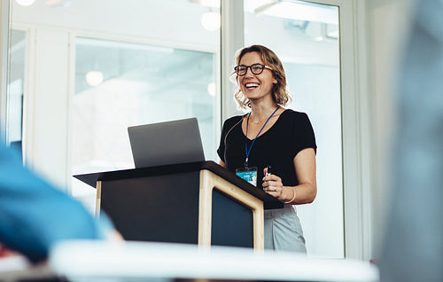 Female business professional addressing a seminar
