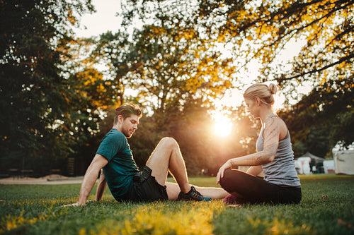 Man and woman exercising at park in morning