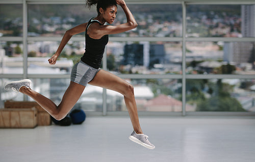 Healthy african woman working out at gym