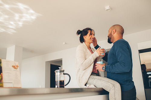 Loving young couple together in kitchen