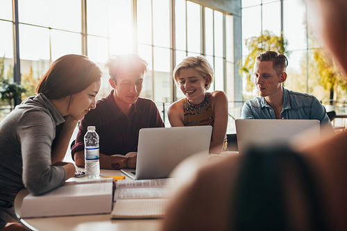 Young people using laptop in class