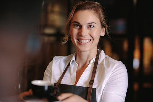 Female barista inside a coffee shop