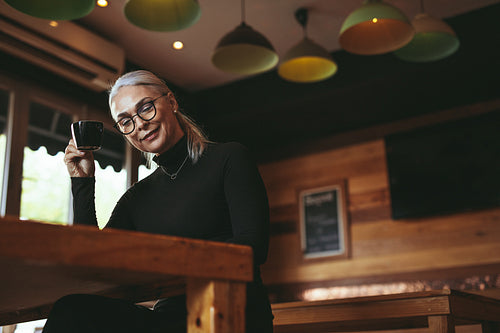 Senior woman relaxing at coffee shop