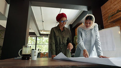 Female collaboration in a design office: Two women working together on an architecture project
