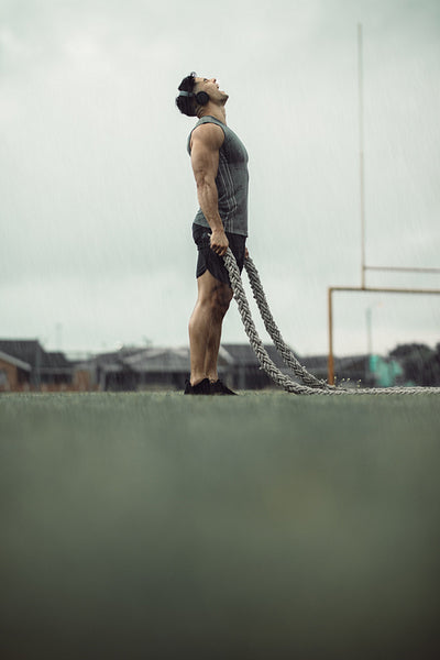 Man feeling energetic during battle rope workout