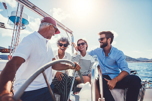 Family enjoying a summer day on a yacht