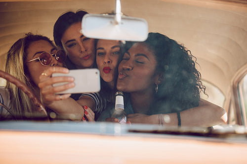 Girls taking selfie on a road trip