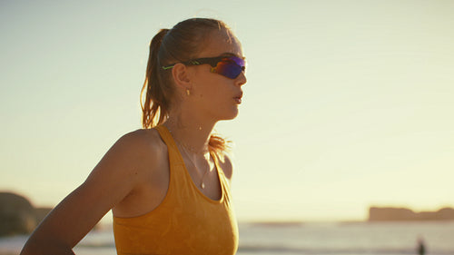 Dynamic medium shot of female beach volleyball athletes between points