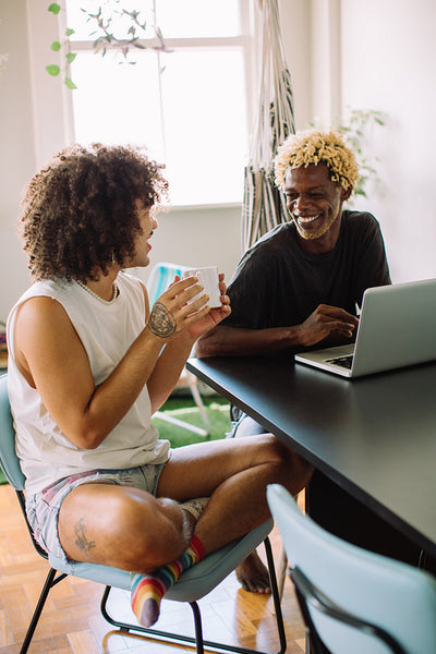 Happy young gay couple following their morning routine at home