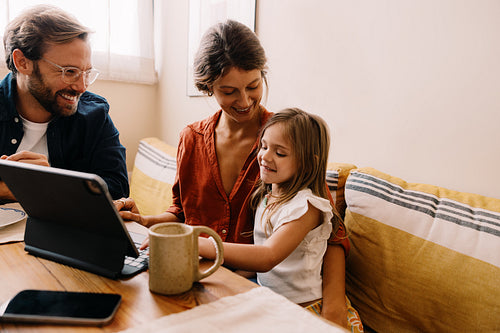 Family uses tablet together at home