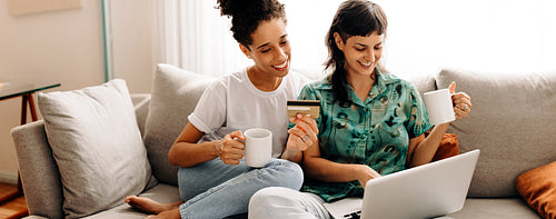 Married lesbian couple enjoying an online sale