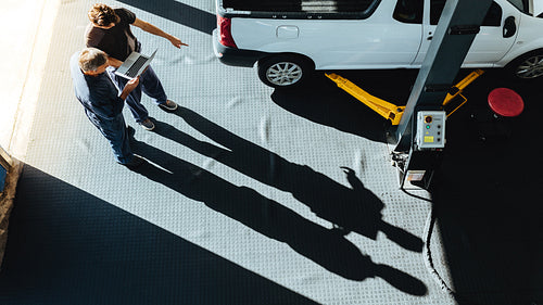 Mechanics working together in auto repair shop