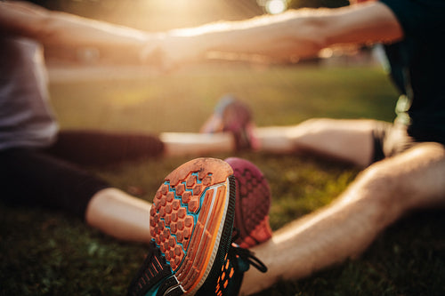 Feet of young man and woman exercising together