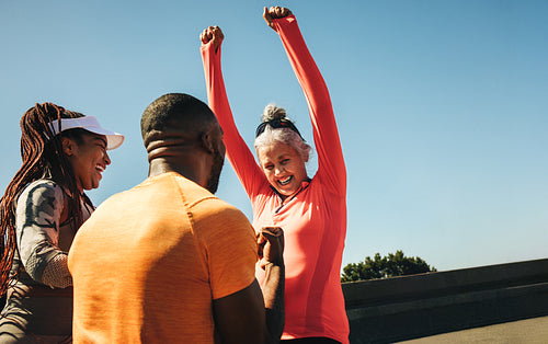 Friends celebrating success after a road running race