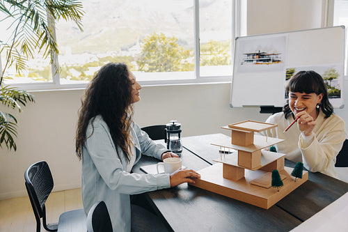 Two female colleagues collaborating during a project planning session in a bright room