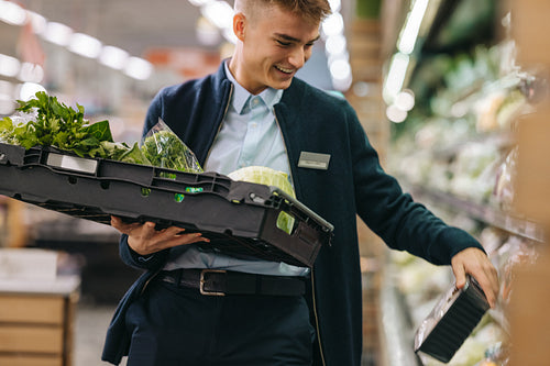 Man working in the supermarket produce section