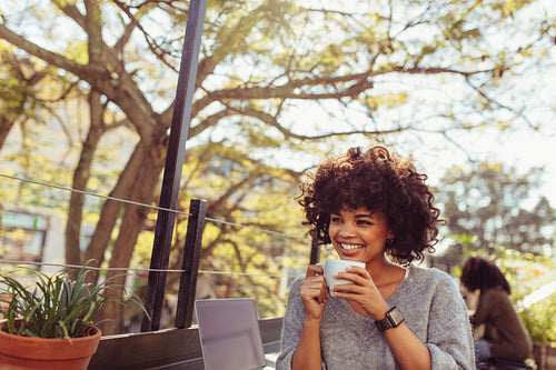 Young woman drinking coffee outdoors