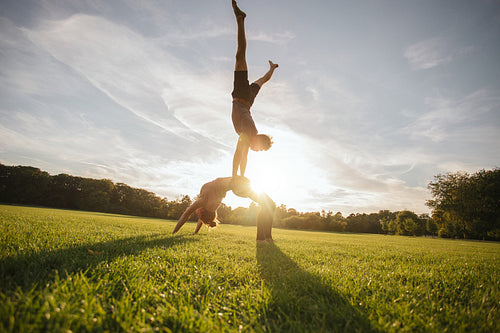 Young man and woman doing yoga in pair
