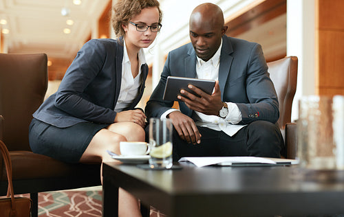 Businesspeople looking at digital tablet
