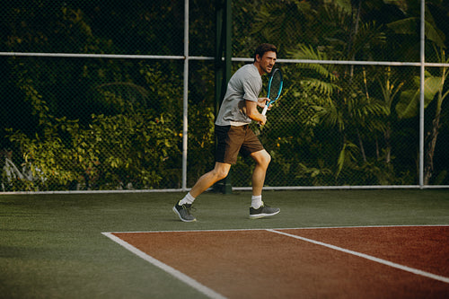 Male tennis player on island vacation