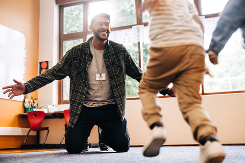 Students running into their teacher’s arms in a primary school