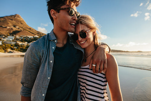 loving young couple walking on beach