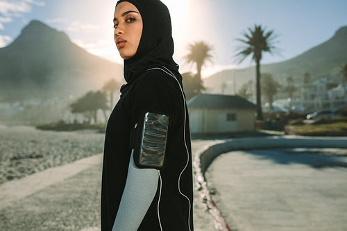 Muslim woman taking a break after morning workout