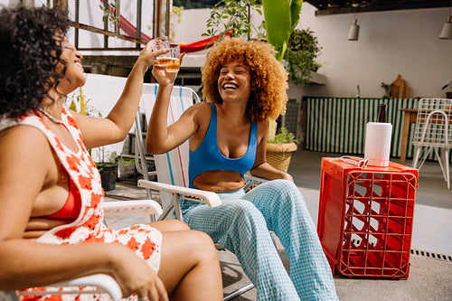 Two friends toasting drinks outdoors in Rio de Janeiro