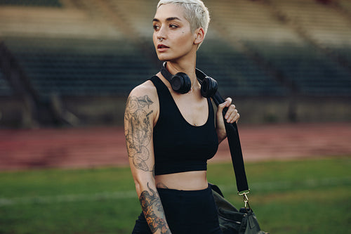 Portrait of a woman athlete walking in a stadium