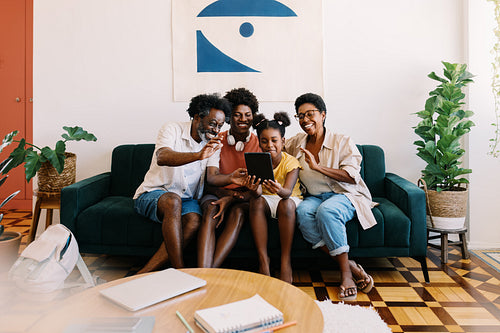 Family time: Happy Brazilian family smiling and video chatting at home