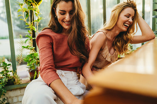 Laughing friends playing the piano
